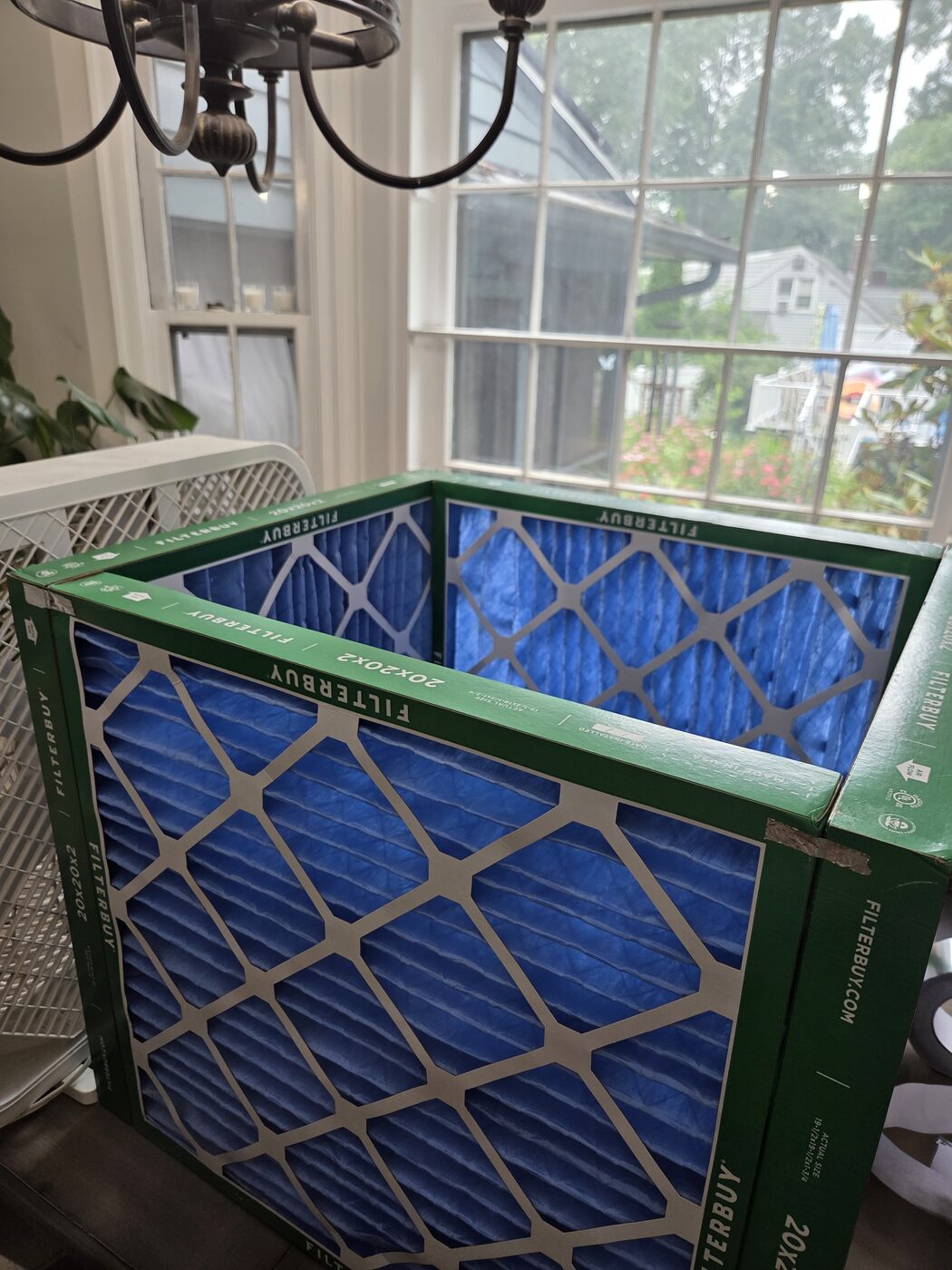 Four filters standing up and taped into an open square tube.